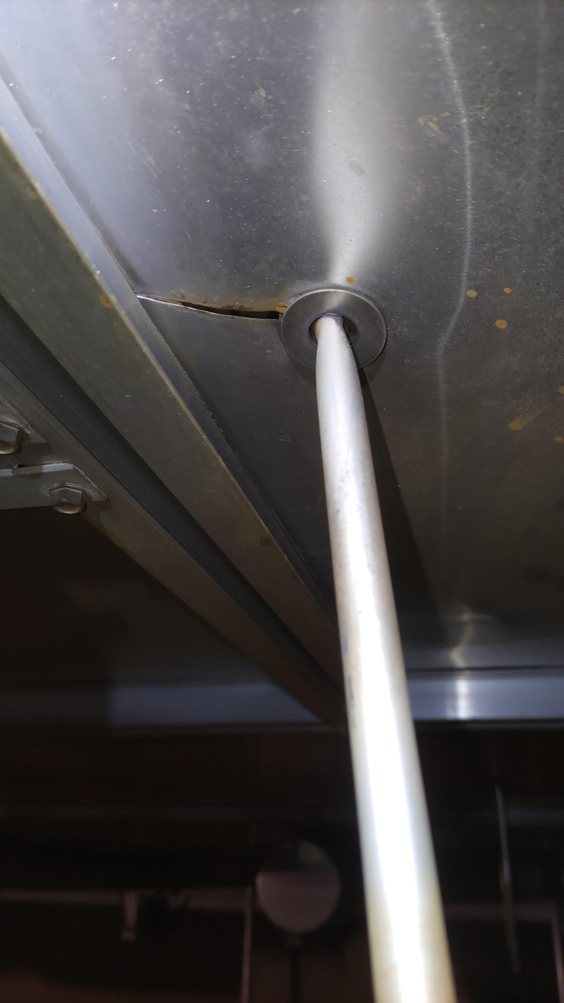 Crack in internal floating roof deck sheeting beside a deck drain