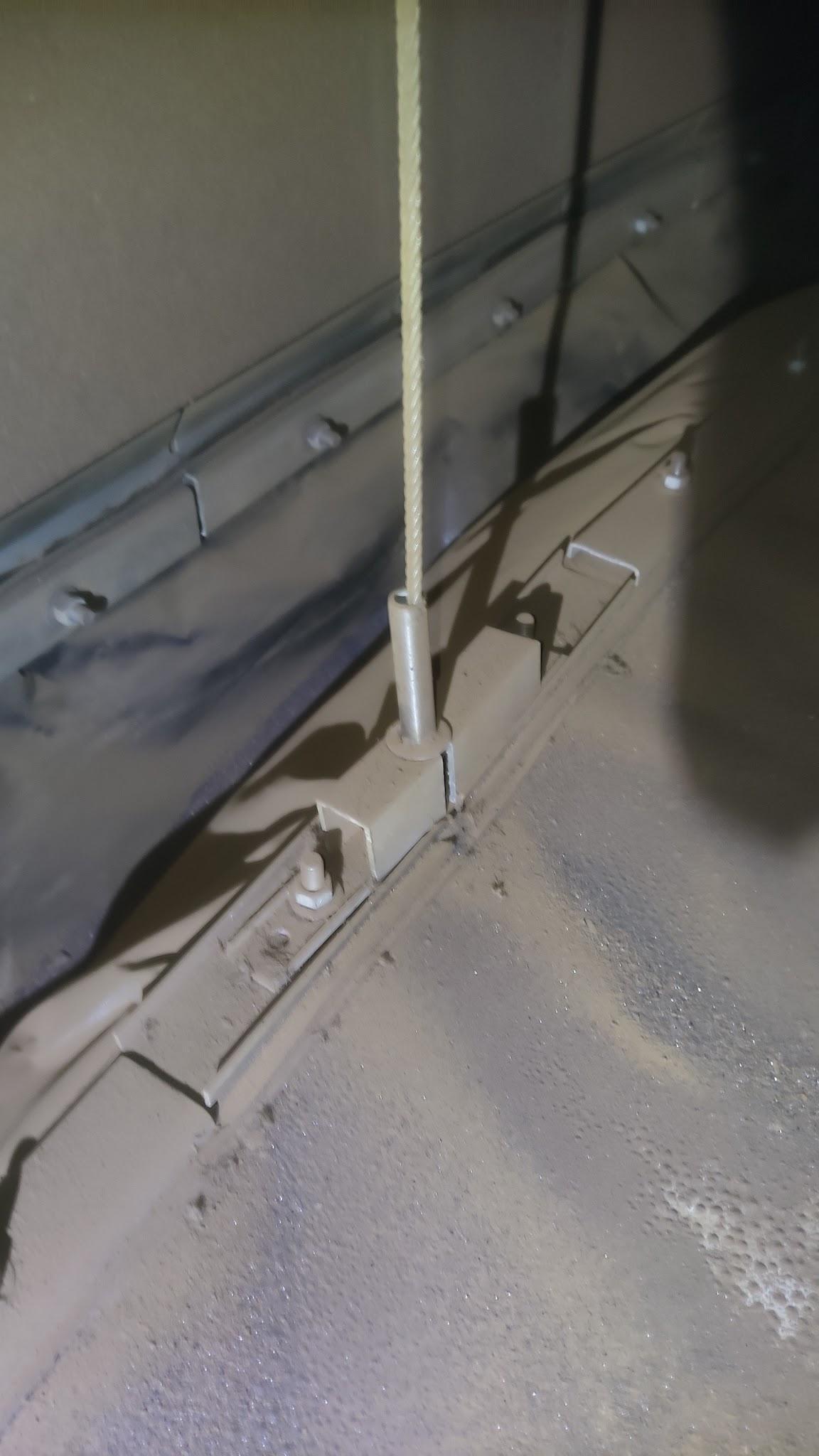 Misaligned anti-rotation cable guide on an internal floating roof